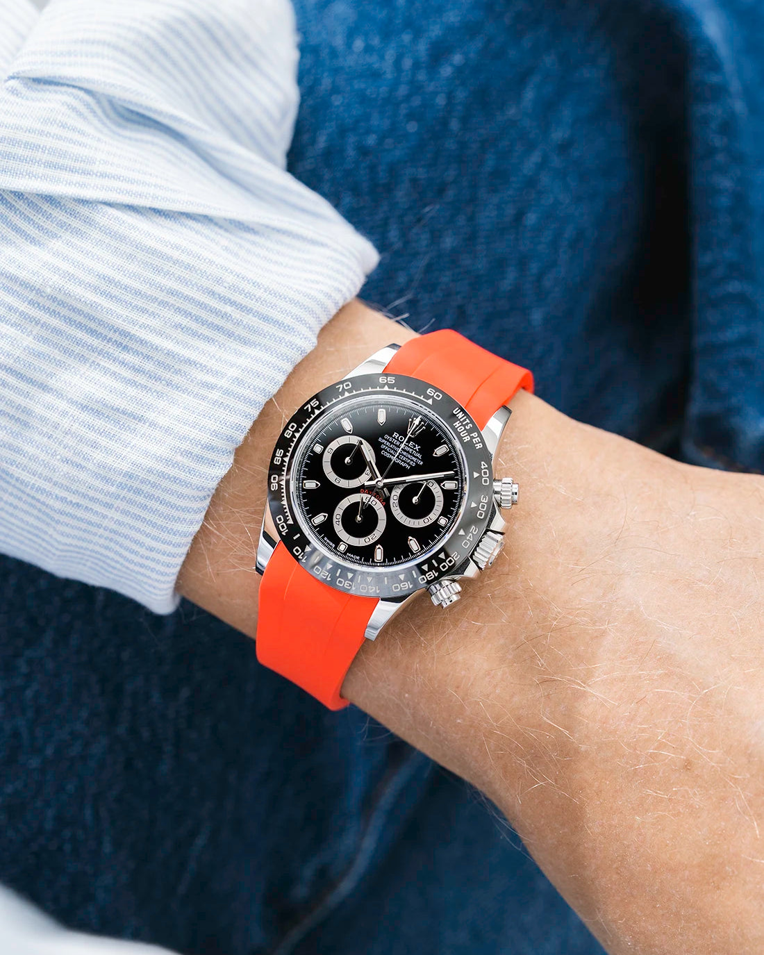 Red integrated FKM rubber strap with original clasp on Rolex Daytona 116500 black dial ceramic bezel wrist shot classic smooth surface