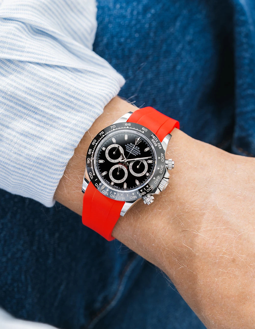 Red integrated FKM rubber strap with original clasp on Rolex Daytona 116500 black dial ceramic bezel wrist shot classic smooth surface