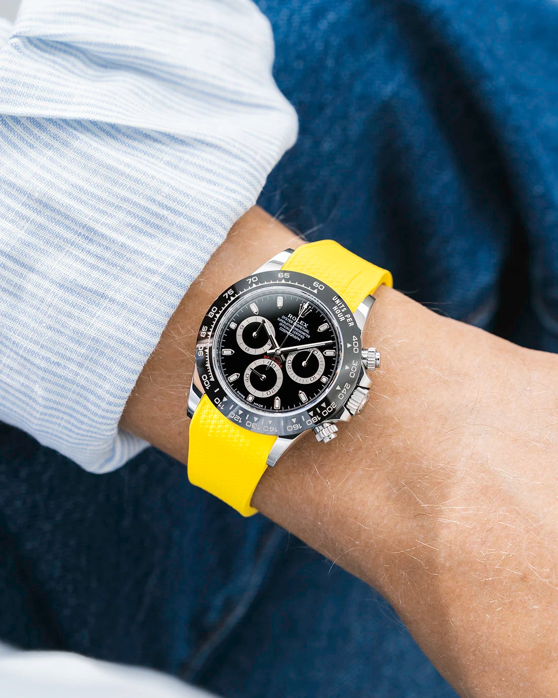 Yellow integrated Vertech FKM rubber strap with original clasp on Rolex Daytona 116500 black dial ceramic bezel wrist shot textured surface