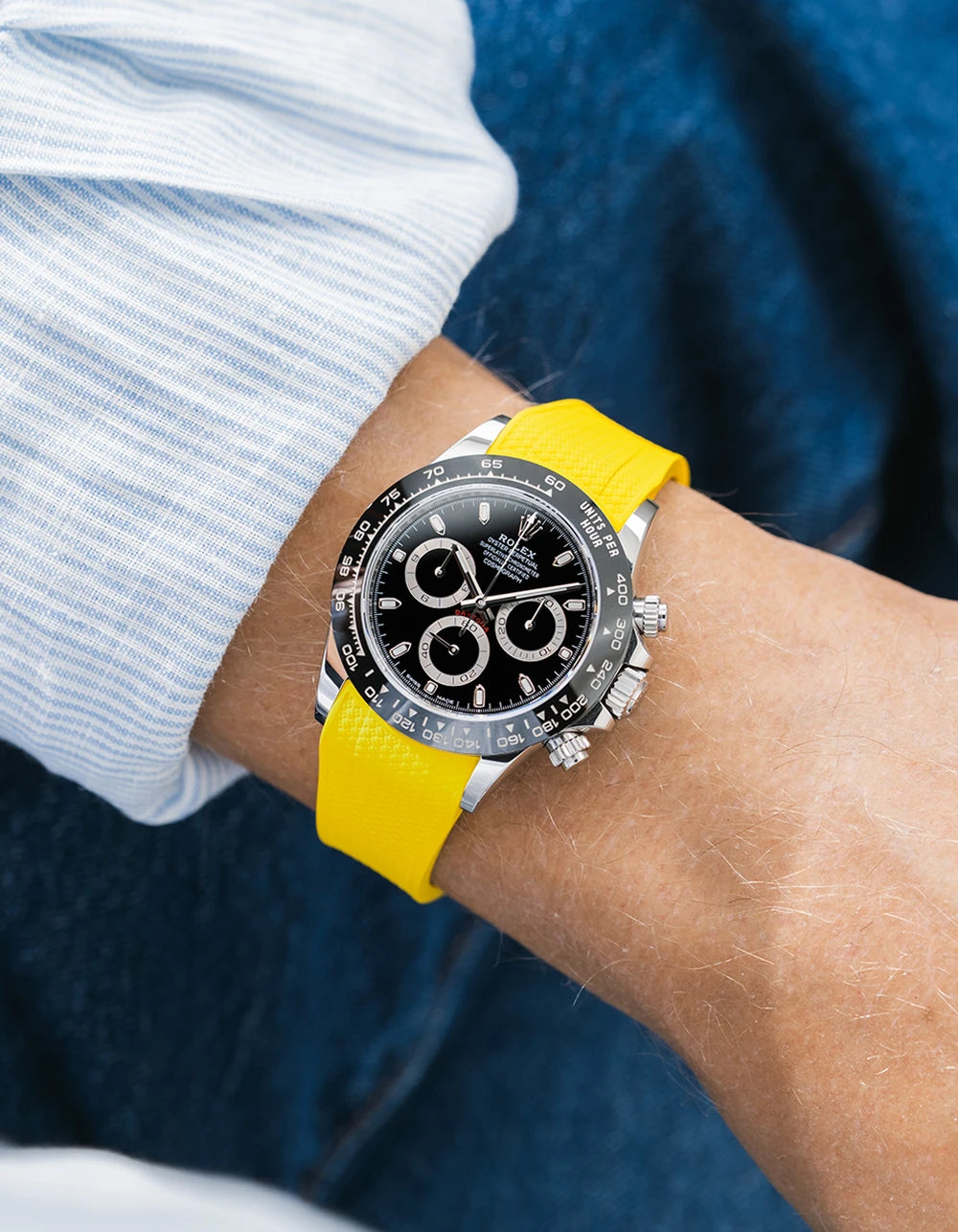 Yellow integrated Vertech FKM rubber strap with original clasp on Rolex Daytona 116500 black dial ceramic bezel wrist shot textured surface