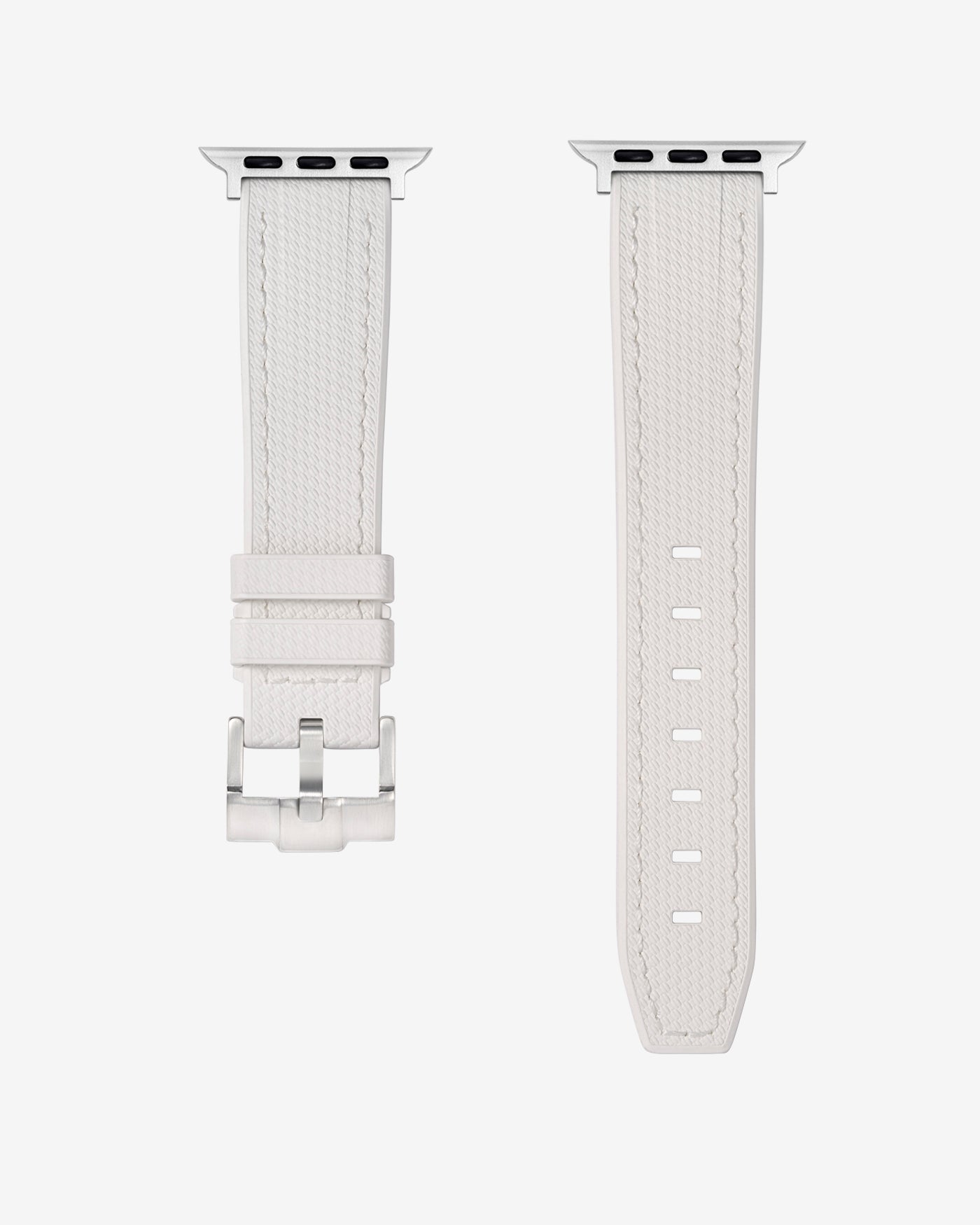 A White rubber apple watch band in detail with silver buckle