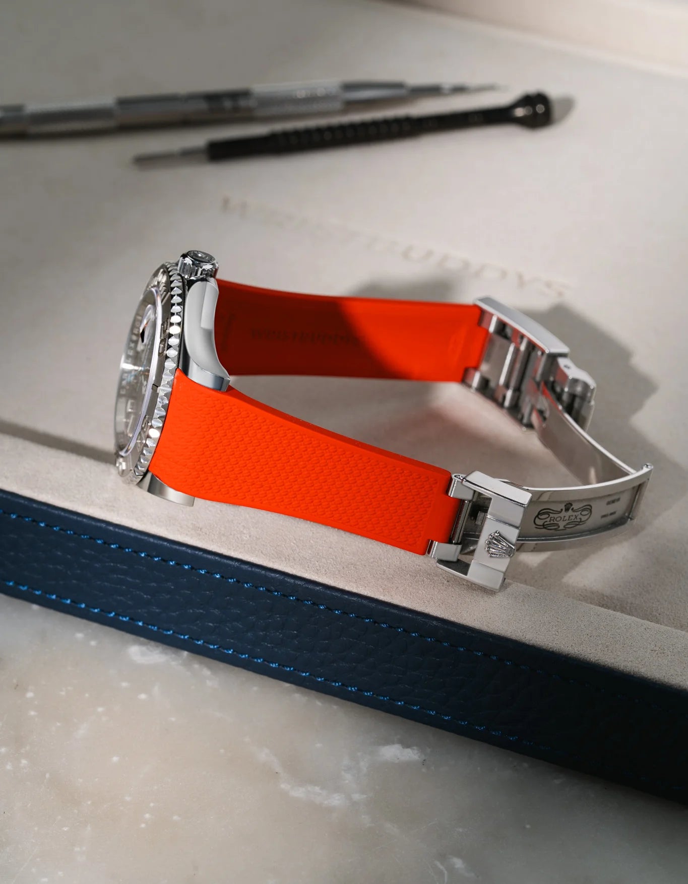Red textured FKM rubber watch band for Rolex Yacht-Master 116622/126622, integrated design for original steel clasp, shown on a premium valet tray.