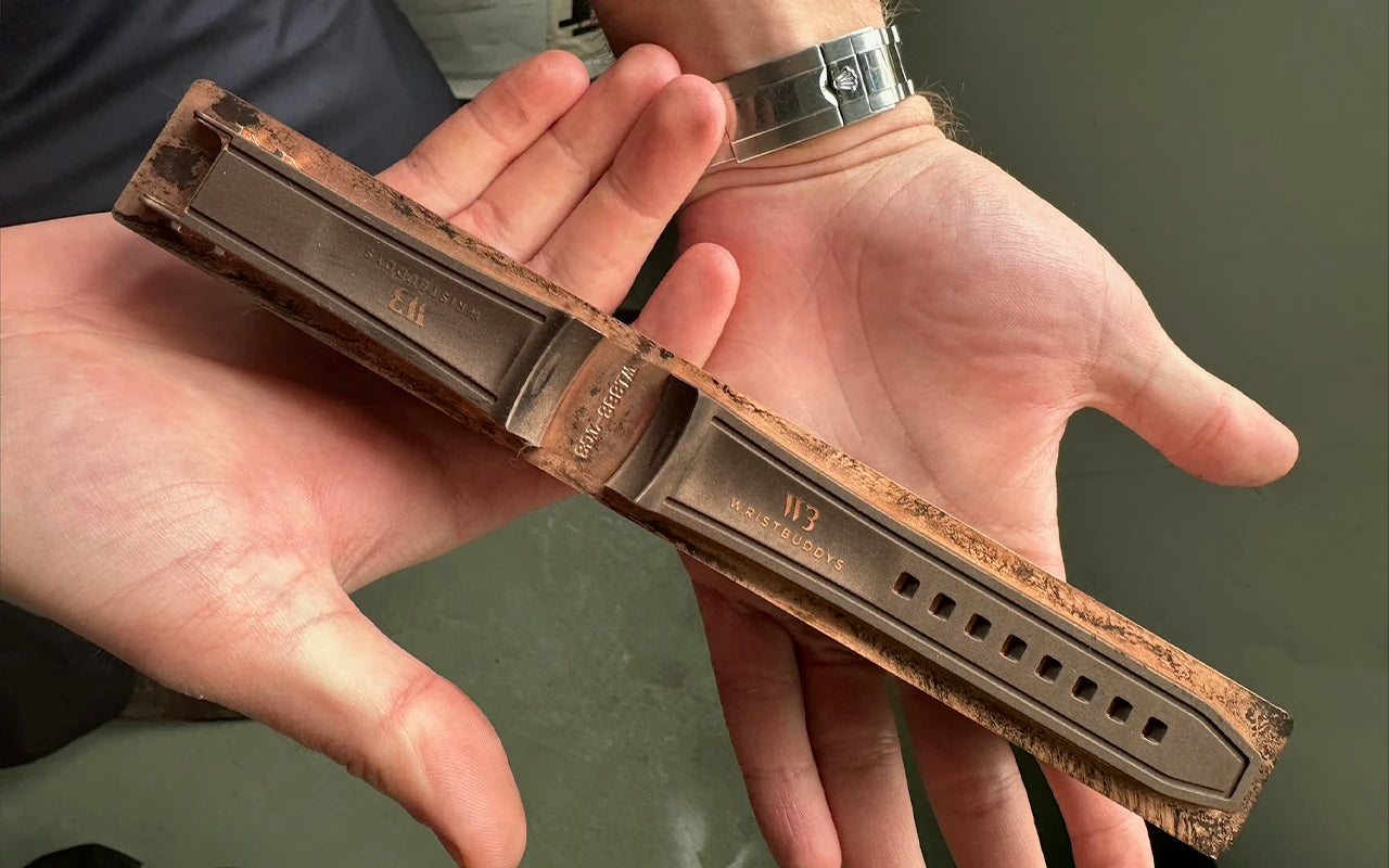 Wristbuddys resin prototype of a rubber watch strap being hand-held during 3D design and fit testing phase