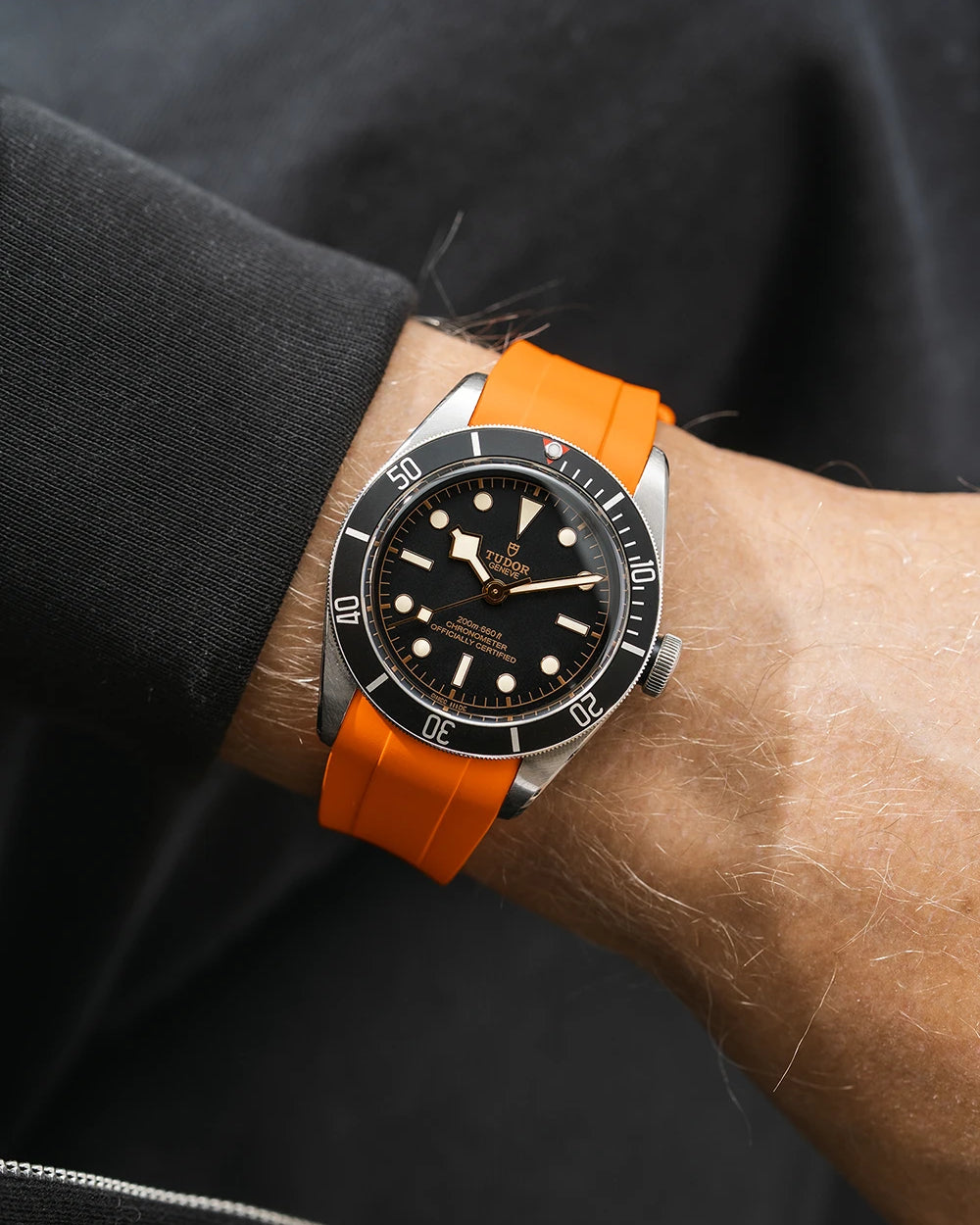 orange FKM rubber watch strap from Wristbuddys with a Tudor BB41 Heritage black dial on a person's wrist