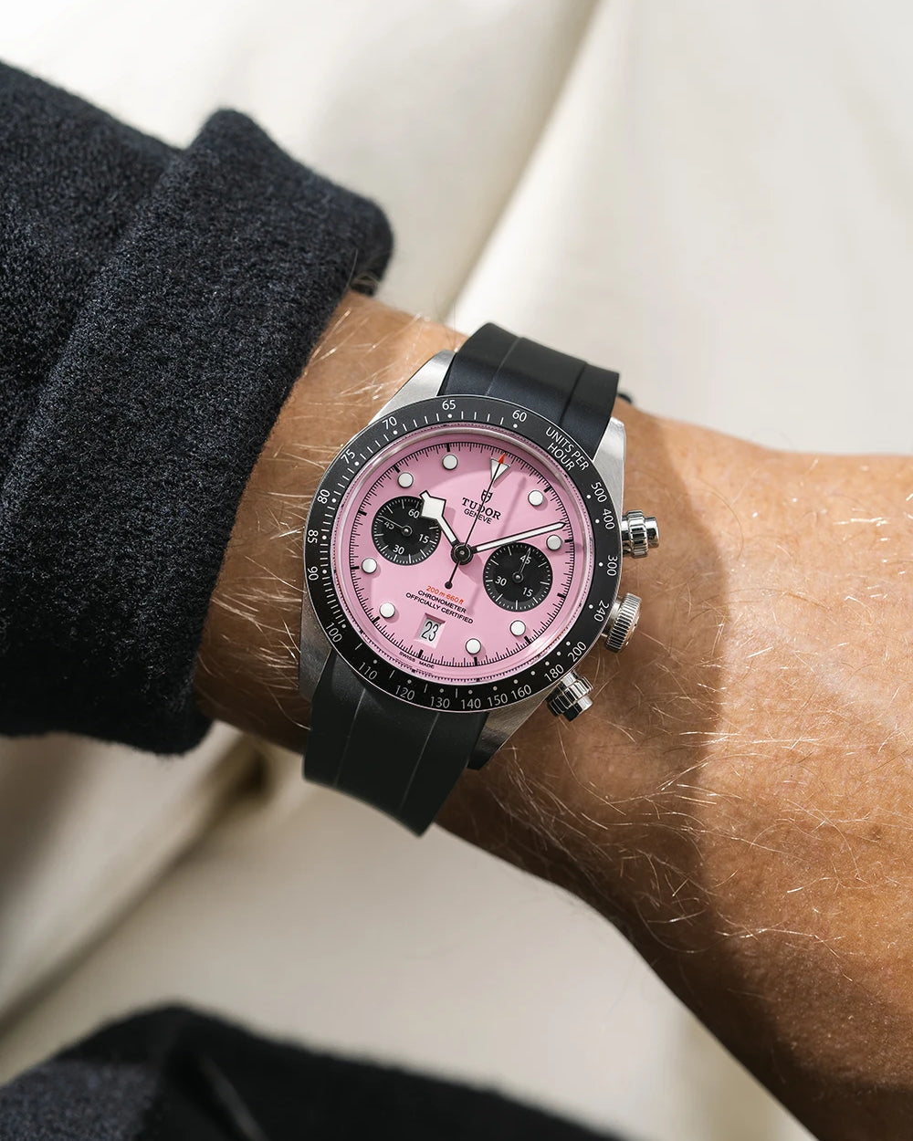 Black FKM rubber watch strap from Wristbuddys with a Tudor Chrono pink dial on a person's wrist