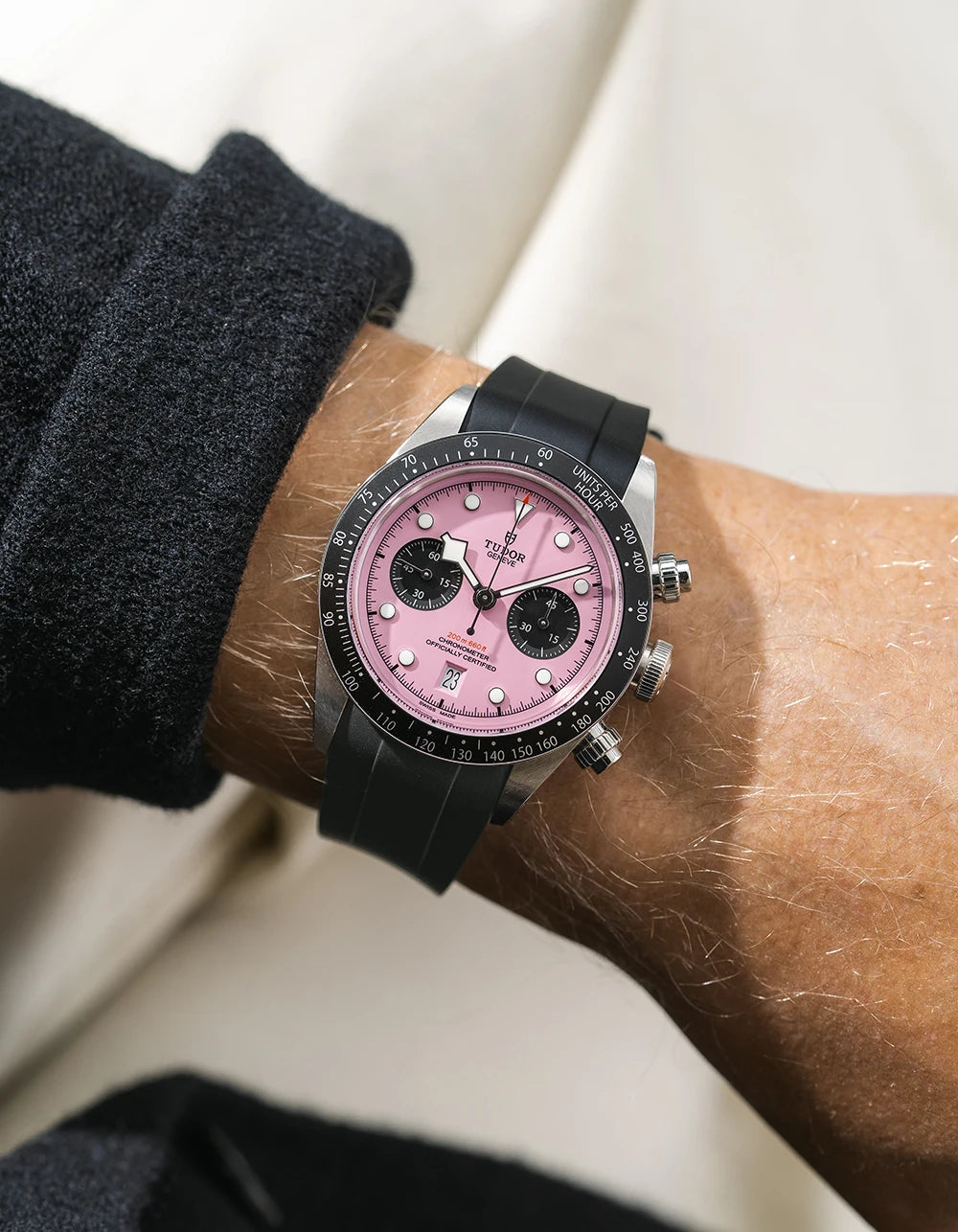 Black FKM rubber watch strap from Wristbuddys with a Tudor Chrono pink dial on a person's wrist
