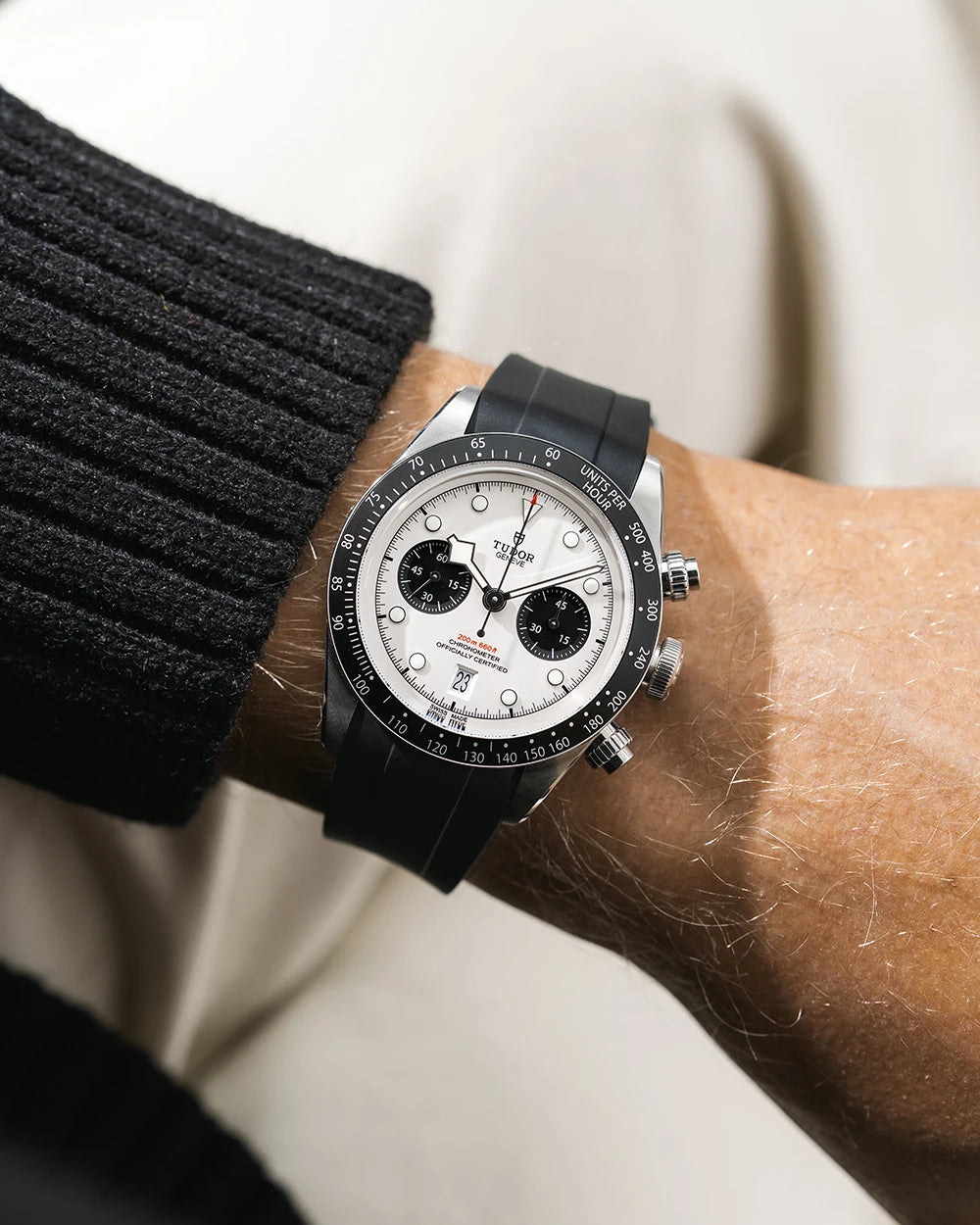 Black FKM rubber watch strap from Wristbuddys with a Tudor Chrono white dial on a person's wrist