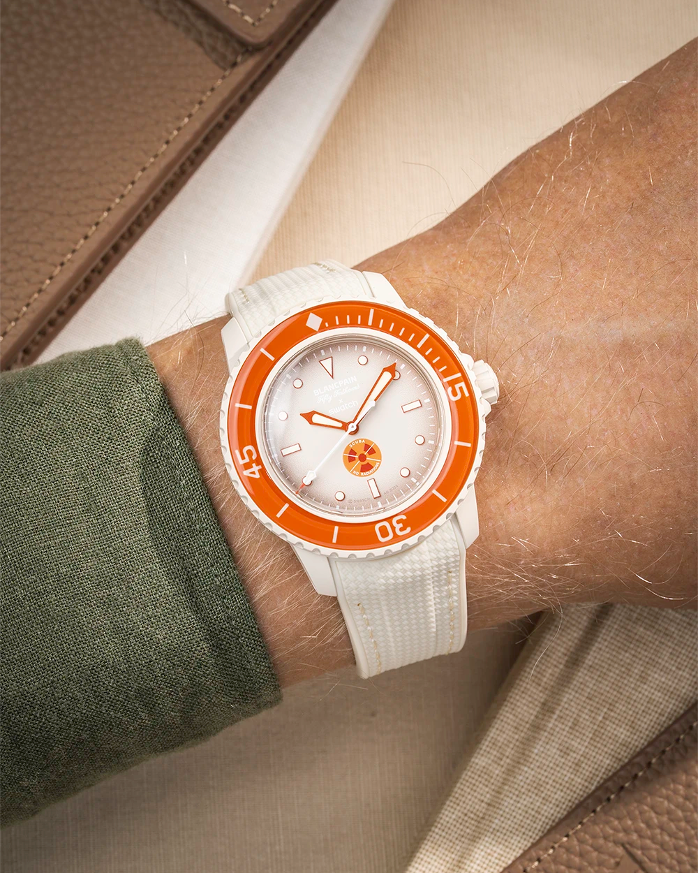 Beige Vertech rubber strap mounted on Blancpain X Swatch Arctic Ocean shown on wrist with silver buckle