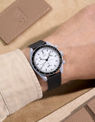Black Epsom leather strap on Omega X Swatch MoonSwatch 1965 | elegant watch band worn with off-white sleeve