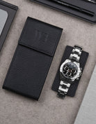 Black leather watch pouch by Wristbuddys with Rolex Daytona resting on pouch lid – luxury travel case for watches