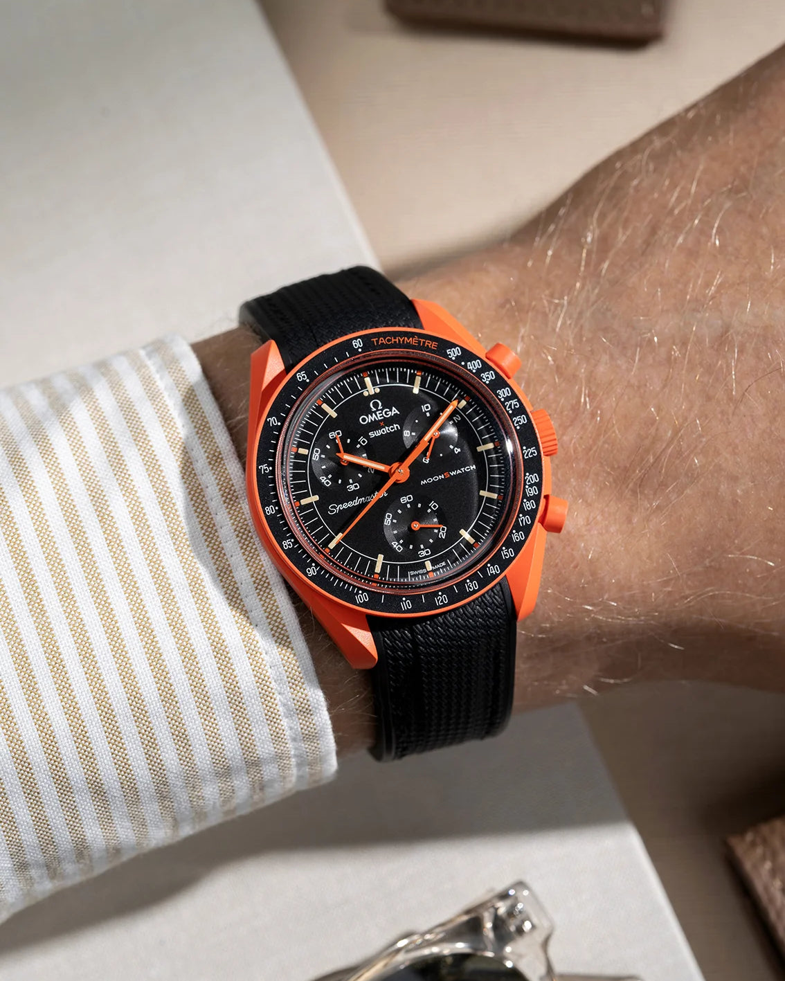 Wrist shot showing black rubber strap for Omega X Swatch MoonSwatch Mission On Earth Lava