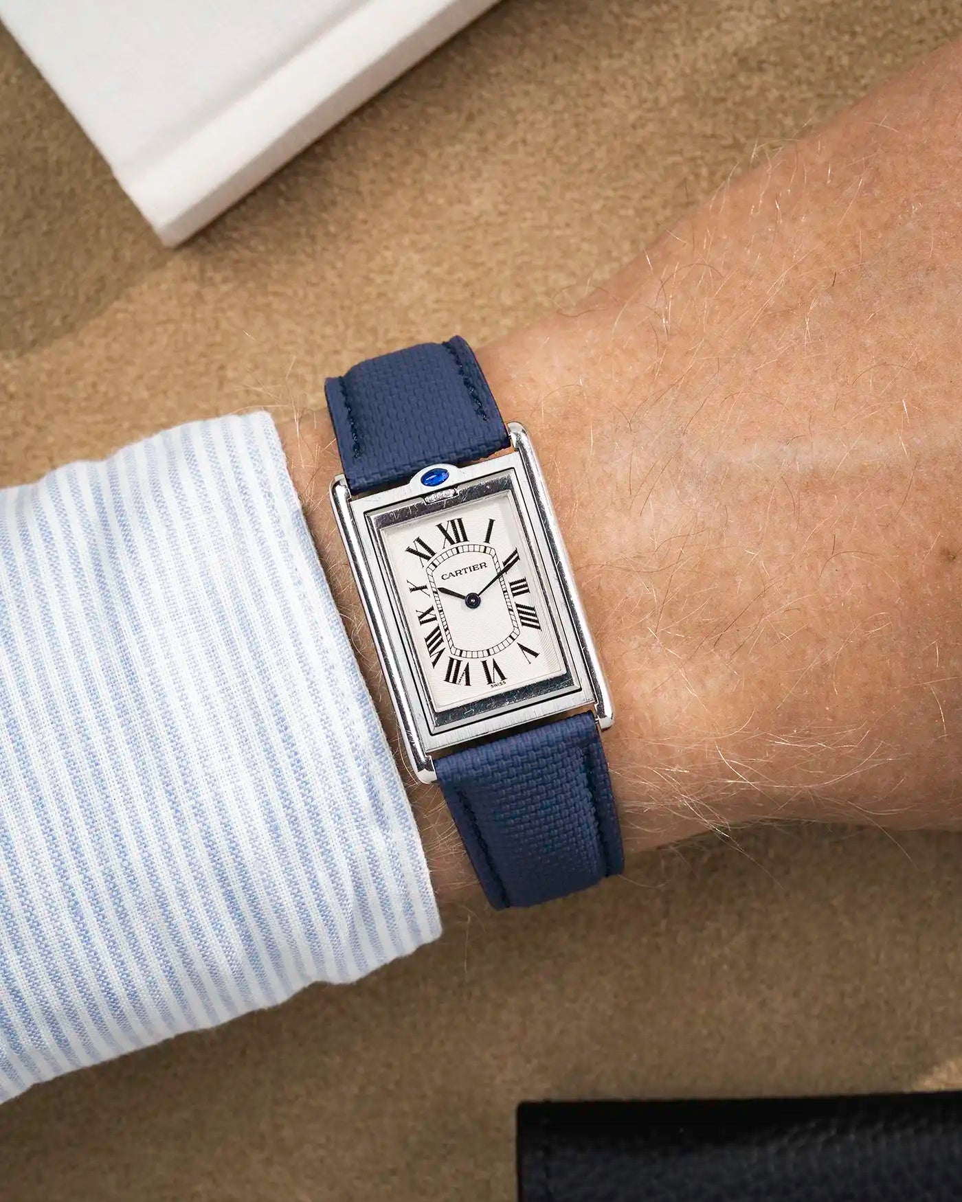 Blue rubberised sailcloth strap variant styled with rectangular silver watch on wrist