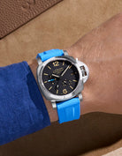 Wrist shot showing Capri Blue Vertech FKM rubber strap on Panerai Luminor GMT