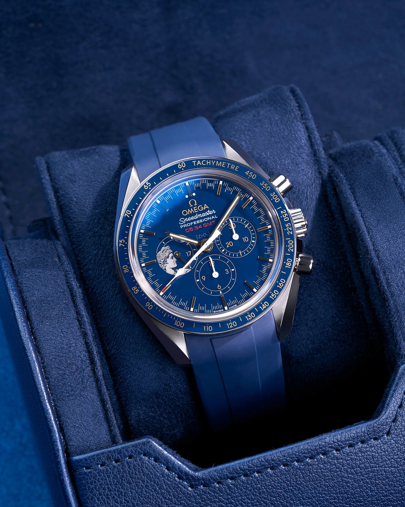 Navy blue watch roll with Sliding System, showcasing an Omega Speedmaster Professional GMT with a blue dial and matching rubber strap, placed on a soft suede sliding cushion for secure and stylish storage