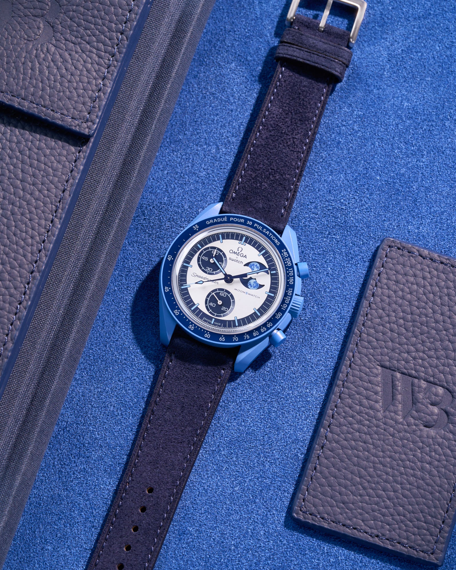 Flat lay of Omega X Swatch Mission to Super Blue Moonphase with Dark Blue suede leather strap