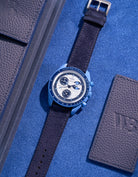 Flat lay of Omega X Swatch Mission to Super Blue Moonphase with Dark Blue suede leather strap