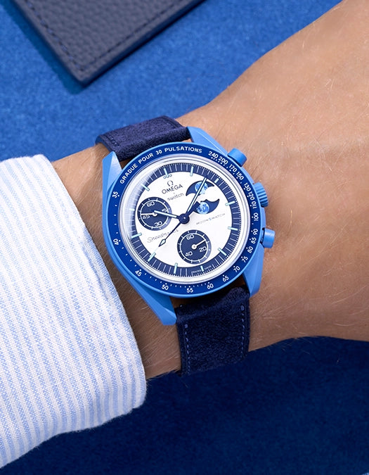Omega X Swatch Mission to Super Blue Moonphase with Dark Blue suede leather strap worn on wrist – styled wrist shot