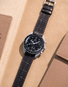 Flat lay of Omega X Swatch MoonSwatch Mission to the Moon with black embossed alligator leather strap