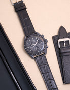 Flat lay of Omega X Swatch MoonSwatch mission to Mercury with black embossed alligator leather strap