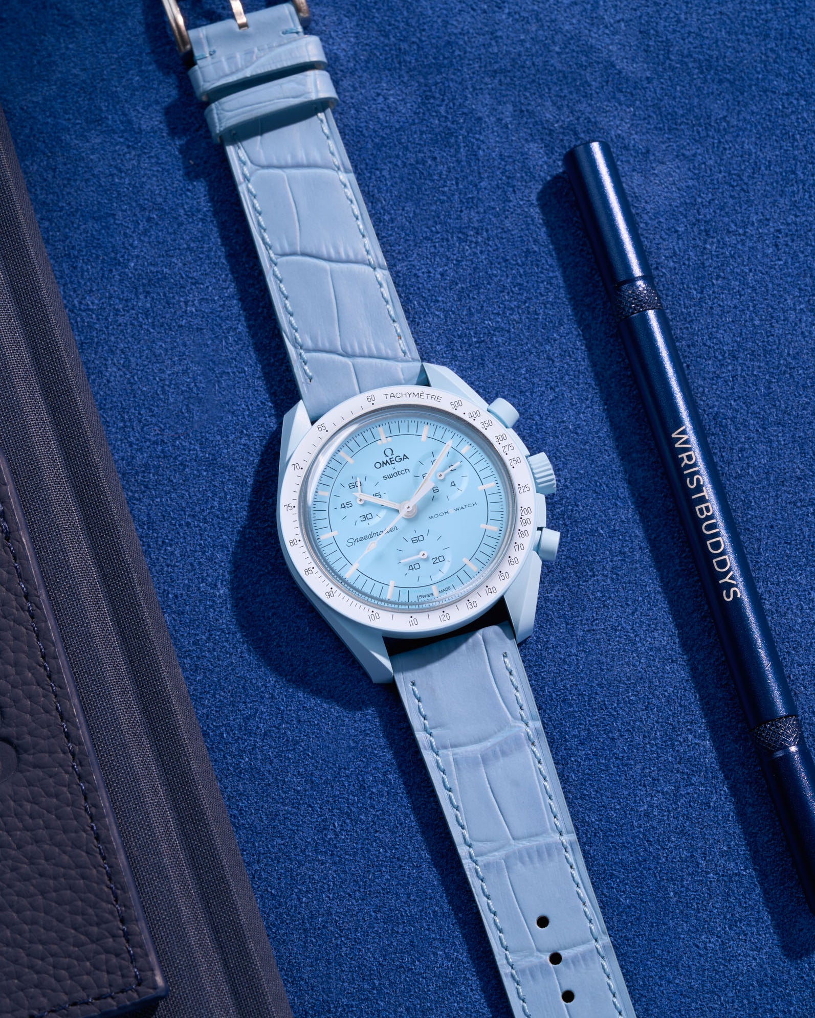 Flat lay of Omega X Swatch MoonSwatch mission to Uranus  with sky blue embossed alligator leather strap