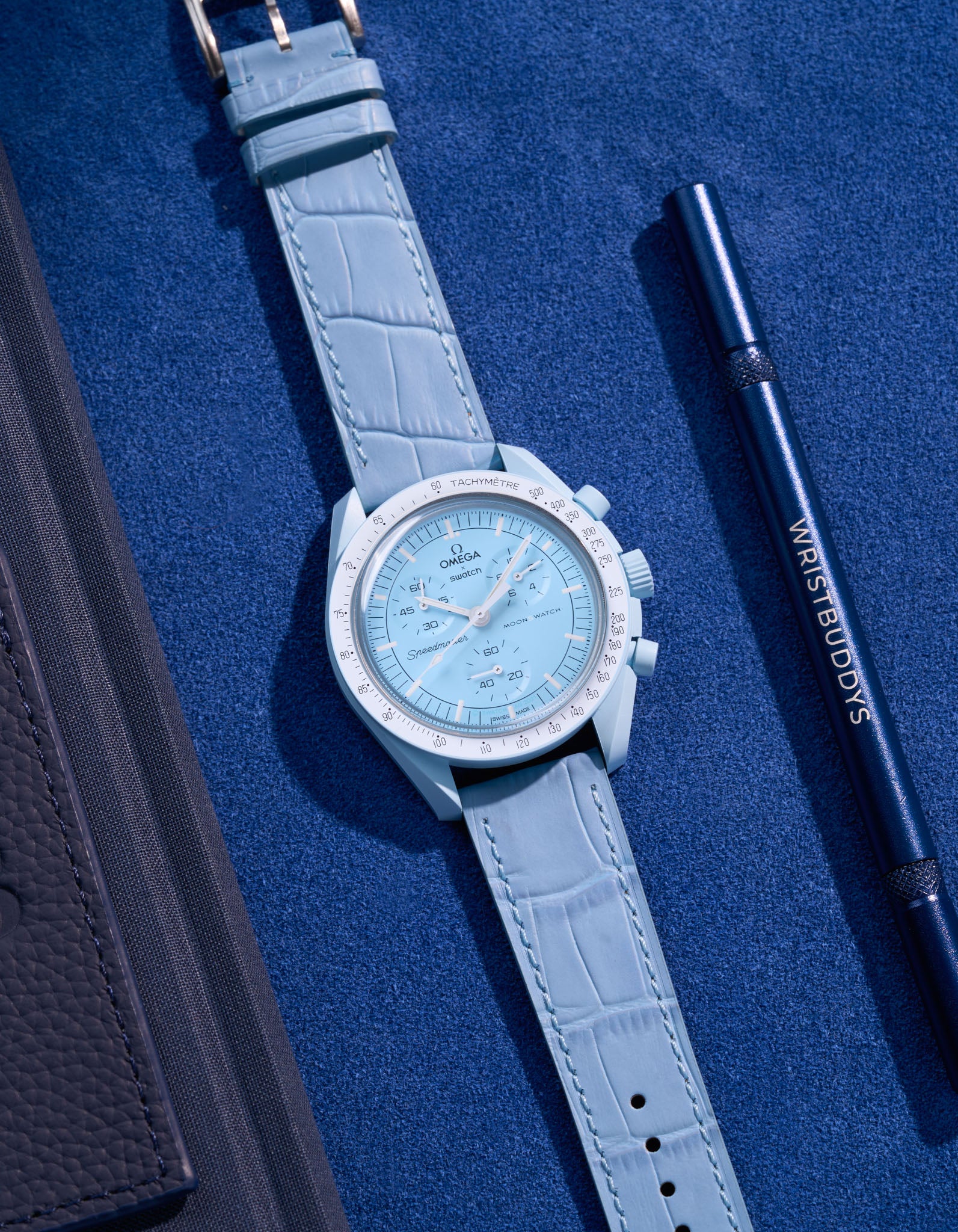 Flat lay of Omega X Swatch MoonSwatch mission to Uranus  with sky blue embossed alligator leather strap