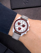 Omega X Swatch Mission to Pluto with Grey suede leather strap worn on wrist – styled shot with black accessories