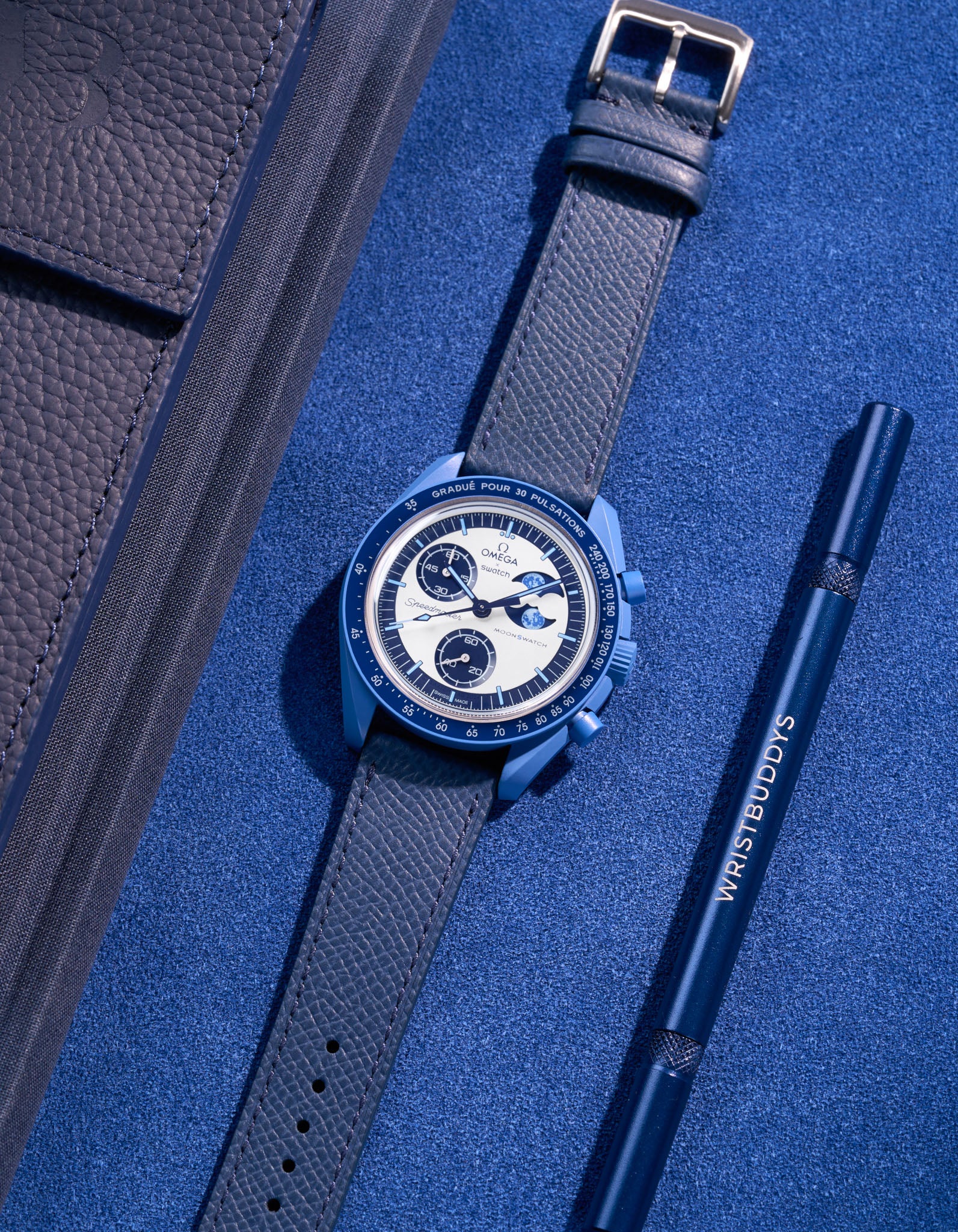 Flat lay of Dark Blue Epsom leather strap on Omega X Swatch Mission to Super Blue Moonphase