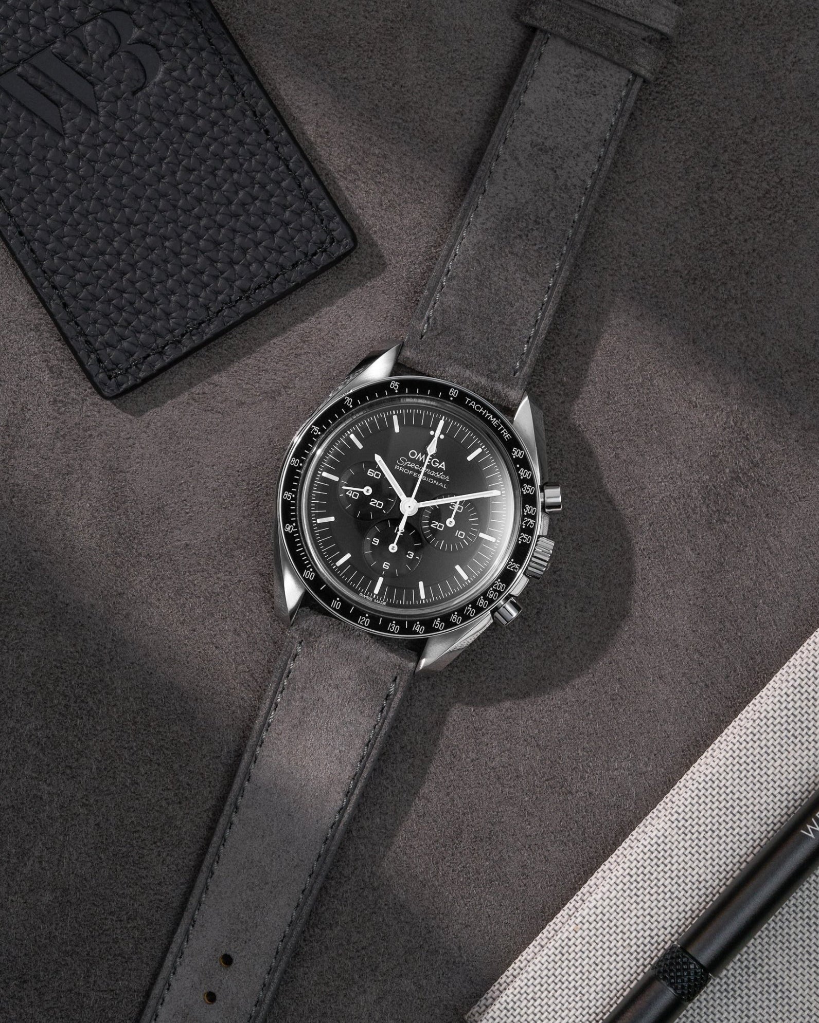 Light Grey Suede Leather Strap  17mm - 21mm on Speedmaster flat lay on grey background