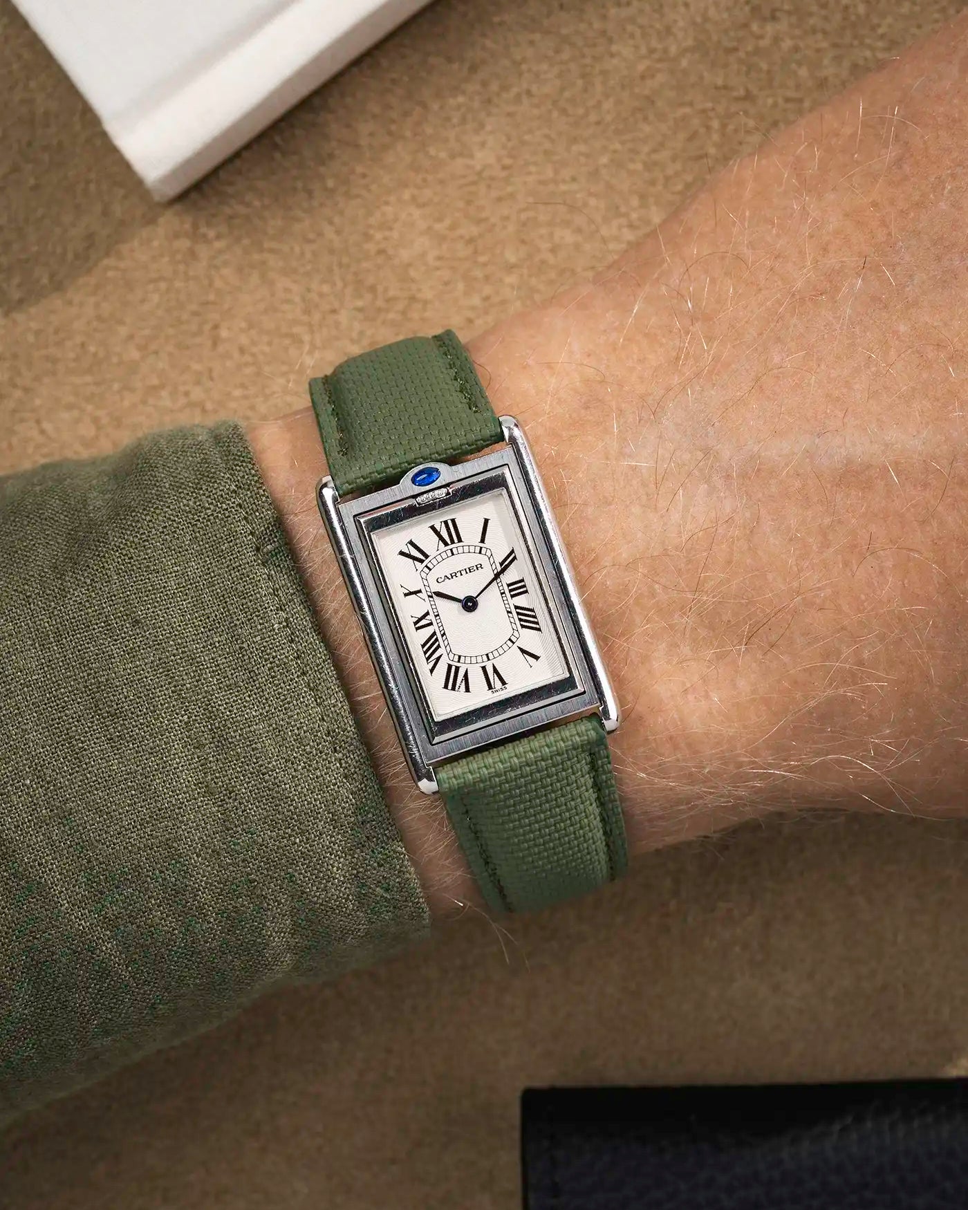 Military green rubberised sailcloth strap on Cartier Tank Louis with white dial – casual yet refined look