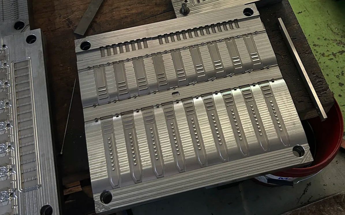High-precision aluminum mold used in Wristbuddys rubber watch strap manufacturing process for consistent shaping