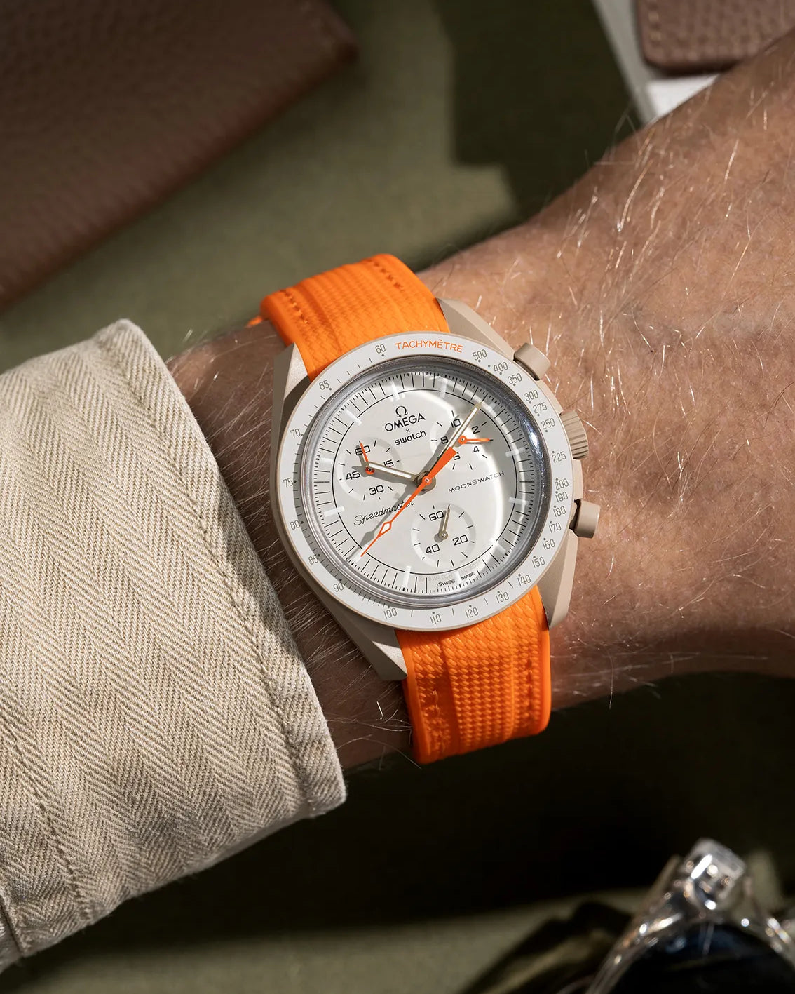 Curved rubber strap for MoonSwatch Mission to Jupiter – orange band designed specifically for the Jupiter model, shown on wrist