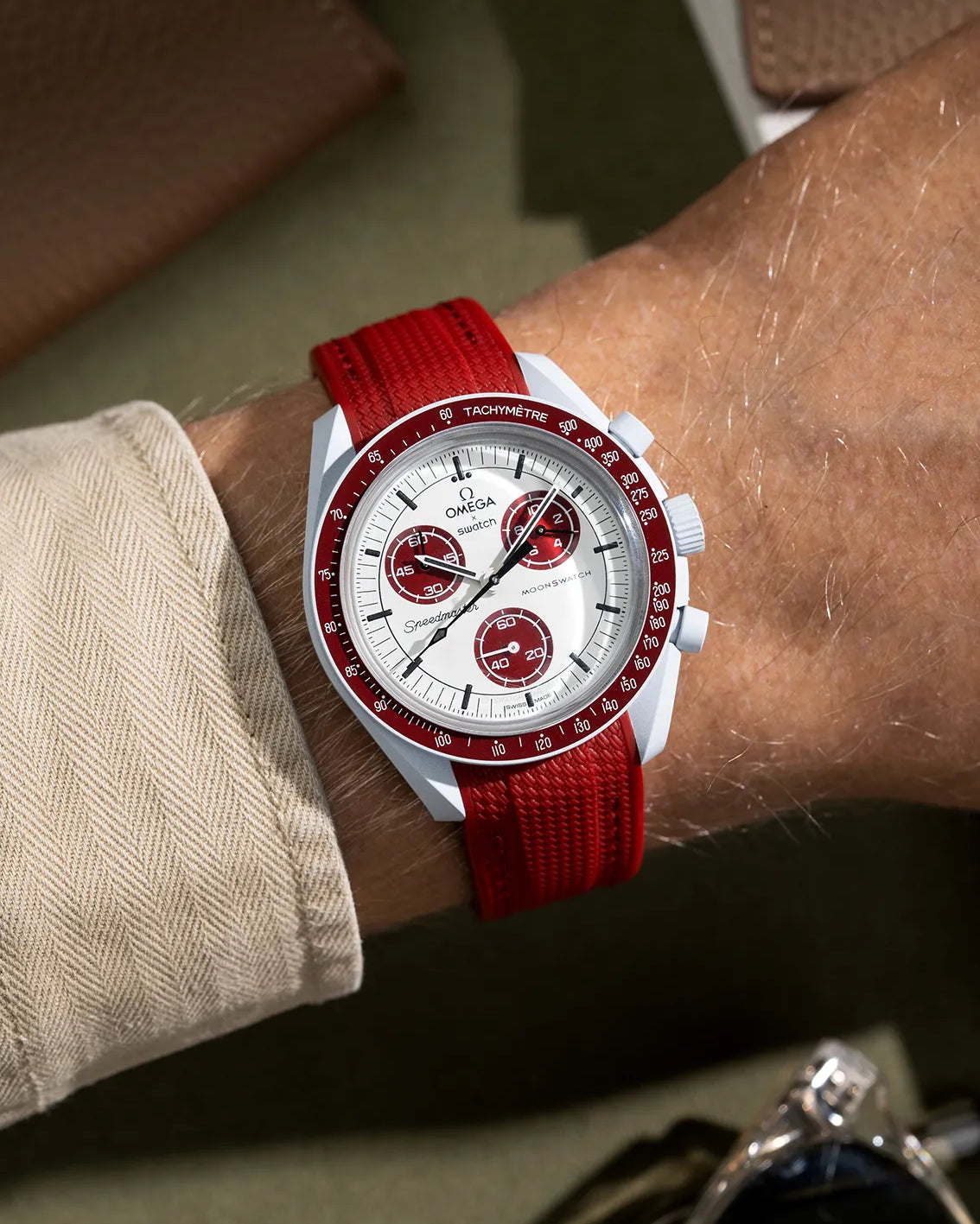Burgundy rubber strap for MoonSwatch Mission to Pluto – shown on wrist