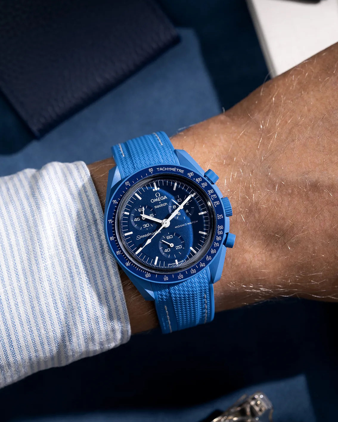Blue and white rubber strap for Omega MoonSwatch, shown on wrist with matching blue case and dial