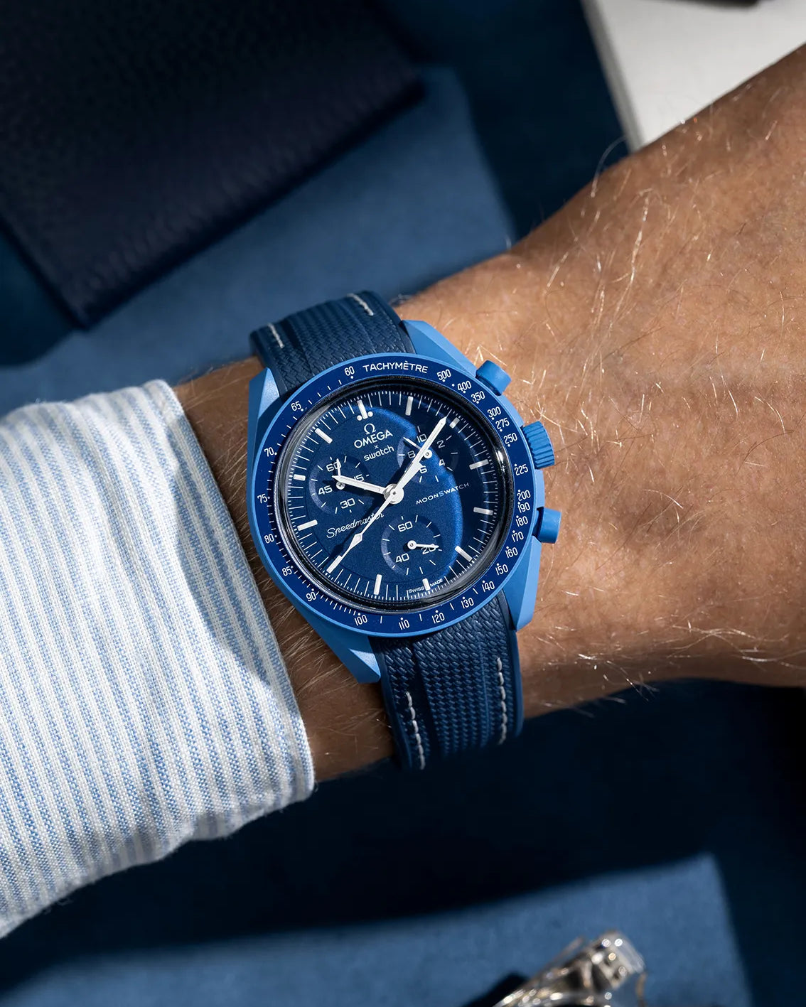 Dark blue and white rubber strap on Omega X Swatch MoonSwatch Mission to Neptune, styled on wrist with tonal harmony