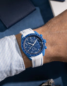 White rubber strap with blue stitching on Omega X Swatch MoonSwatch Neptune, wrist shot showing clean contrast