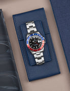 Navy blue leather watch pouch by Wristbuddys with Rolex GMT-Master Pepsi displayed on top – luxury watch storage accessory