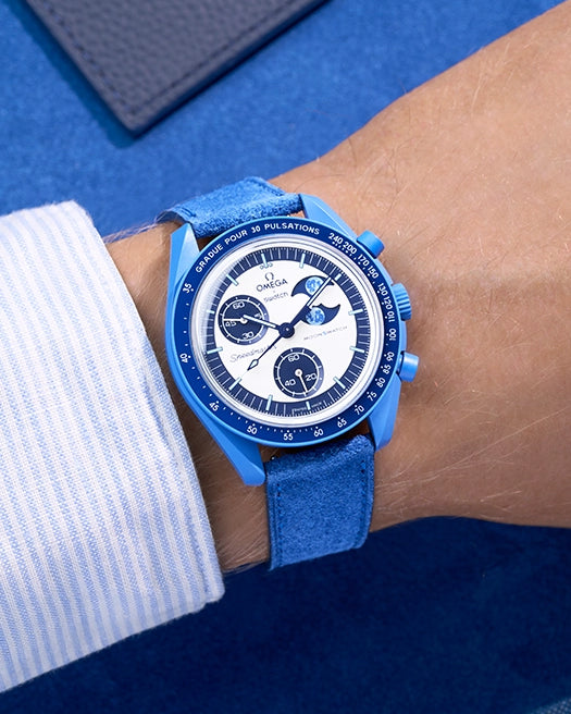 Omega X Swatch Mission to Super Blue Moonphase with Ocean Blue suede leather strap worn on wrist – styled shot