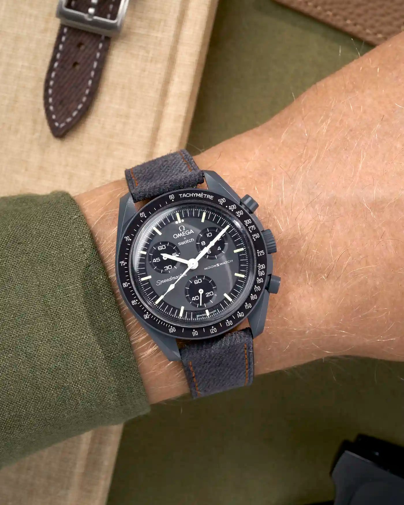 Wrist shot of Omega X Swatch Mission to Mercury with Dark Grey & Orange Stitch Denim Strap – denim texture detail