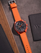 Flat lay of Orange Cowhide leather strap for Omega x Swatch MoonSwatch mission on Earth Lava