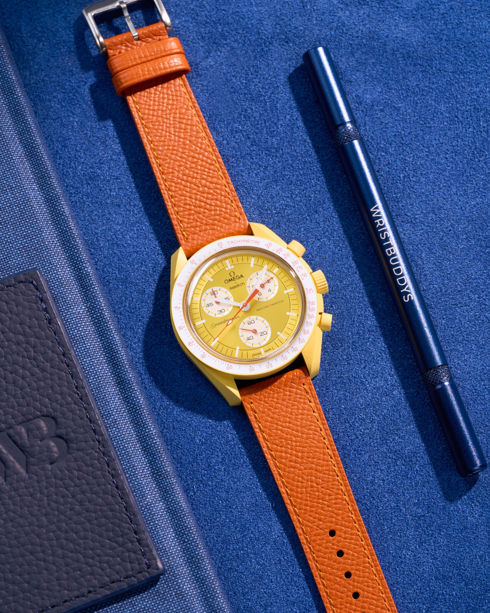 Flat lay of Orange Epsom leather strap for Omega x Swatch MoonSwatch Mission to the Sun