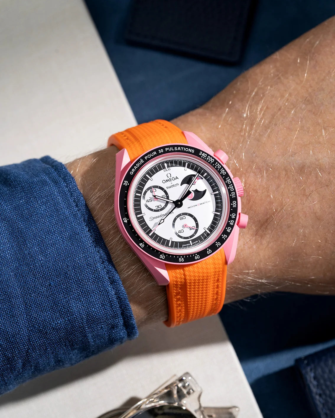 Wrist shot showing orange rubber strap for Omega X Swatch MoonSwatch Mission to the Pink Moonphase