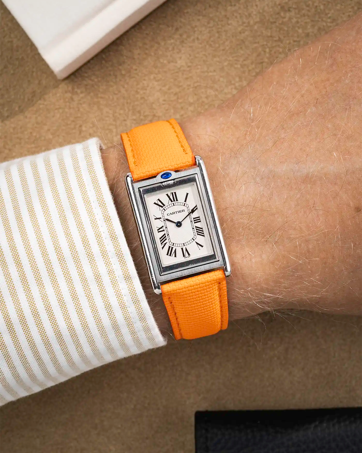 orange rubberised sailcloth strap on wrist with white dial – part of collection overview