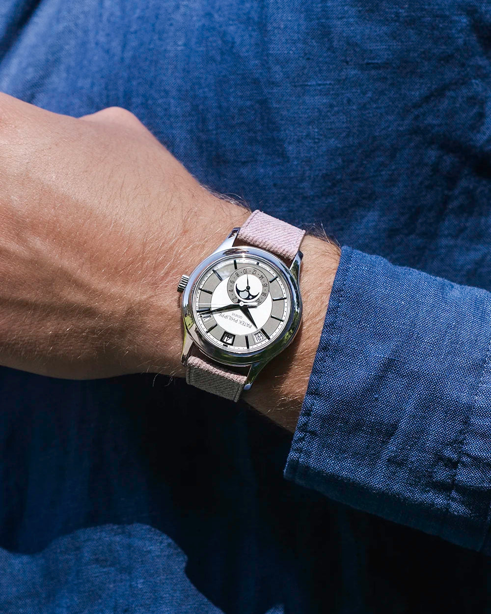 Wrist shot of a watch with Pink Denim Strap 18mm-21mm, shown in natural light against a blue shirt