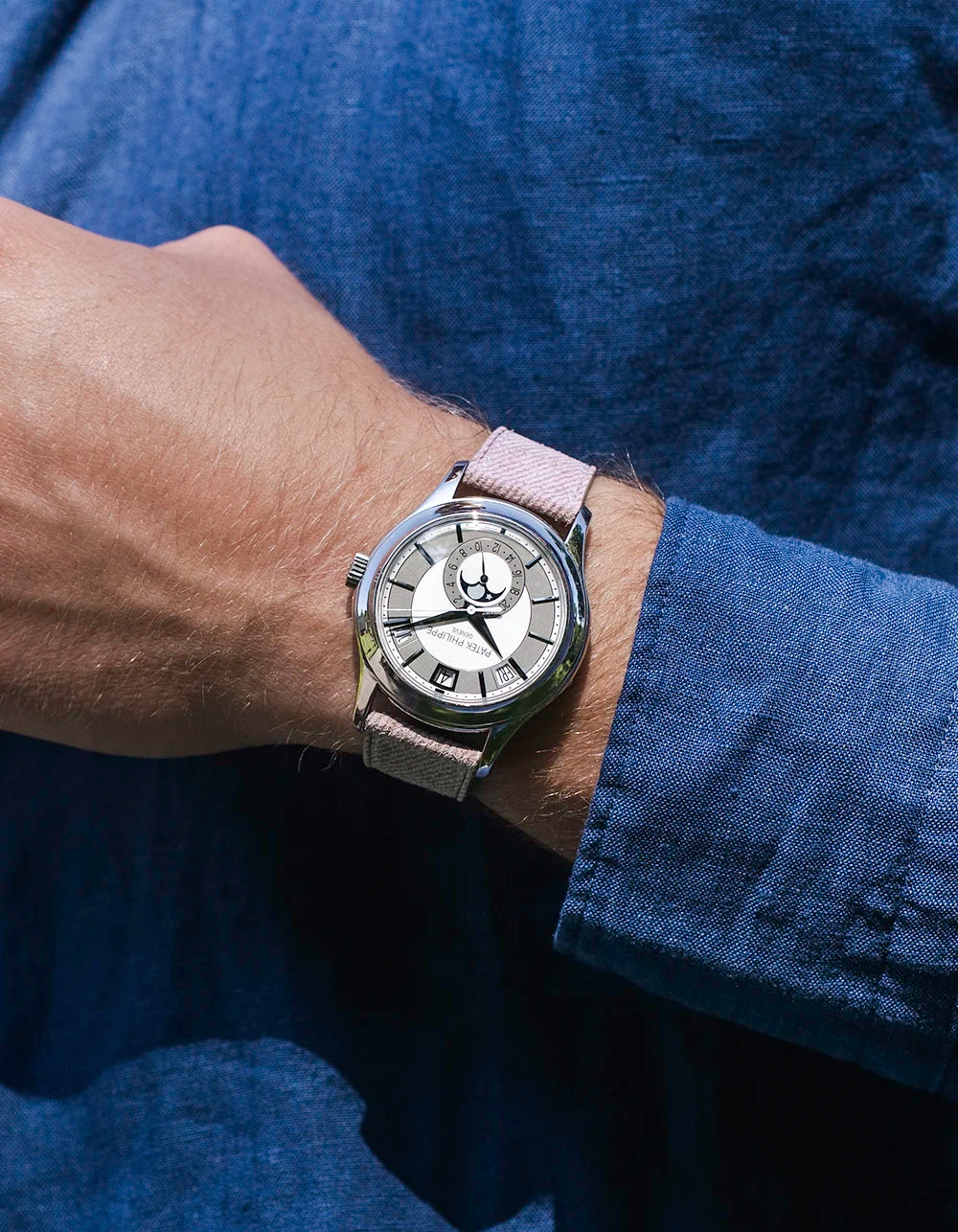 Wrist shot of a watch with Pink Denim Strap 18mm-21mm, shown in natural light against a blue shirt