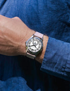 Wrist shot of a watch with Pink Denim Strap 18mm-21mm, shown in natural light against a blue shirt