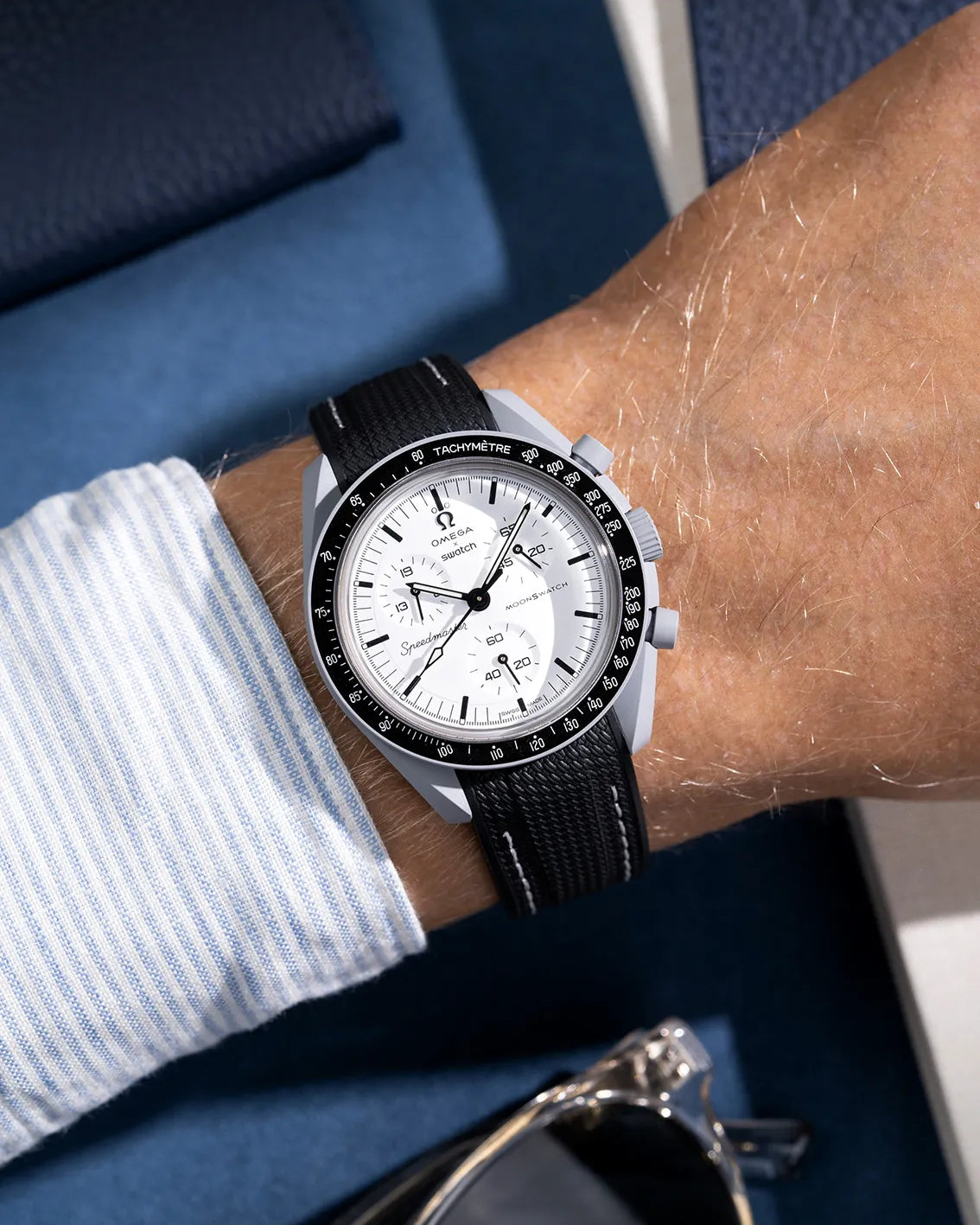 Black vurved vertech rubber strap with white stitches mounted on Omega X Swatch MoonSwatch 1965 model – shown on wrist