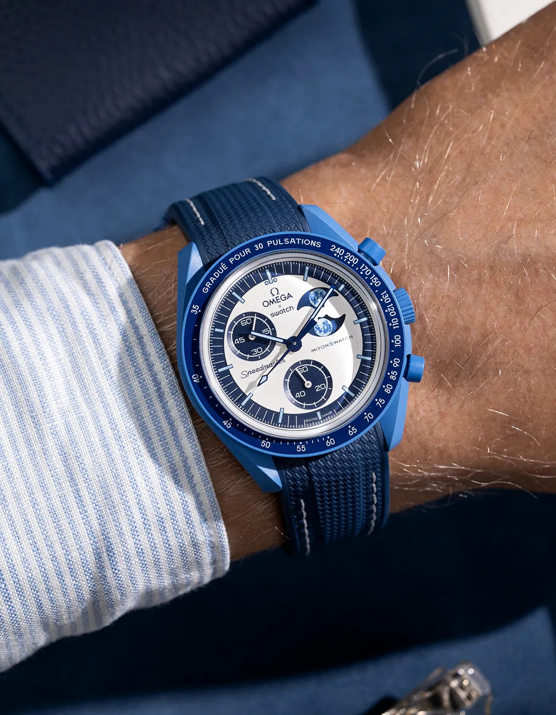 Wrist shot of blue rubber strap with white stitching for MoonSwatch, photographed on the Mission to the Super Blue Moonphase