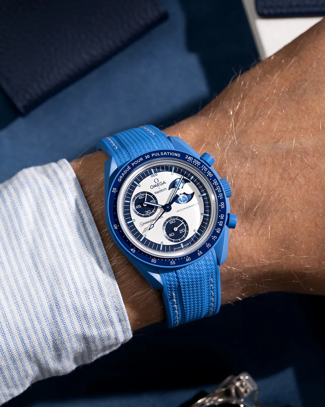 Wrist shot of neptune blue rubber strap with white stitching for MoonSwatch, photographed on the Mission to the Super Blue Moonphase