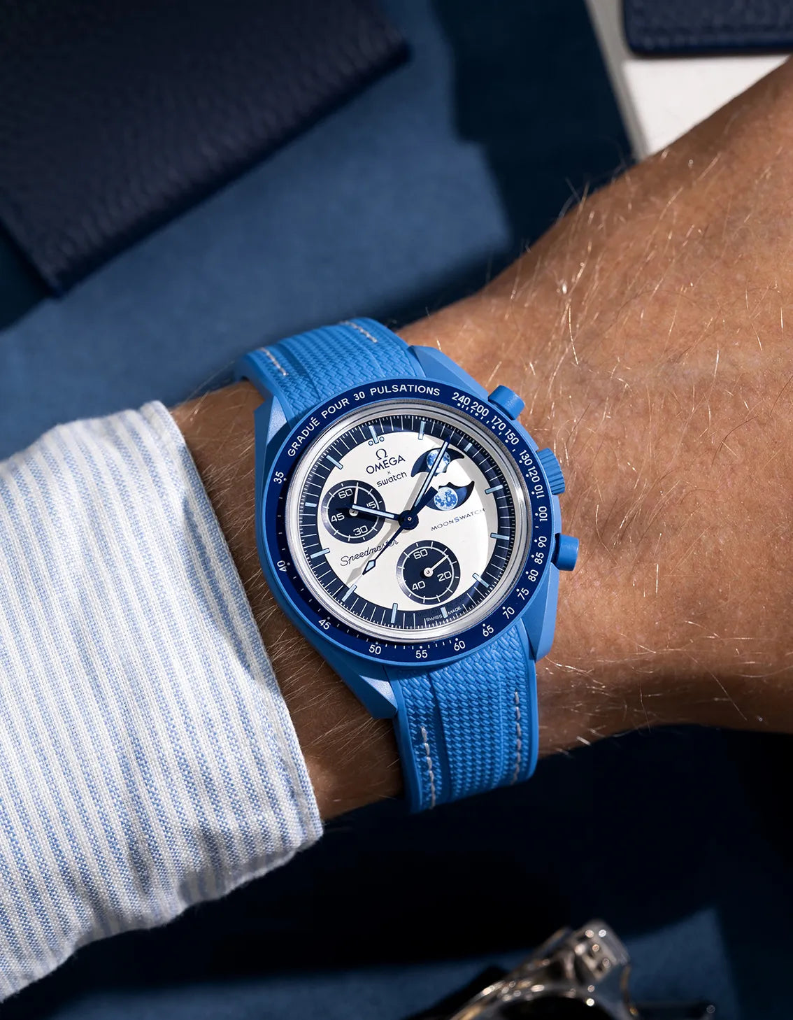 Wrist shot of neptune blue rubber strap with white stitching for MoonSwatch, photographed on the Mission to the Super Blue Moonphase