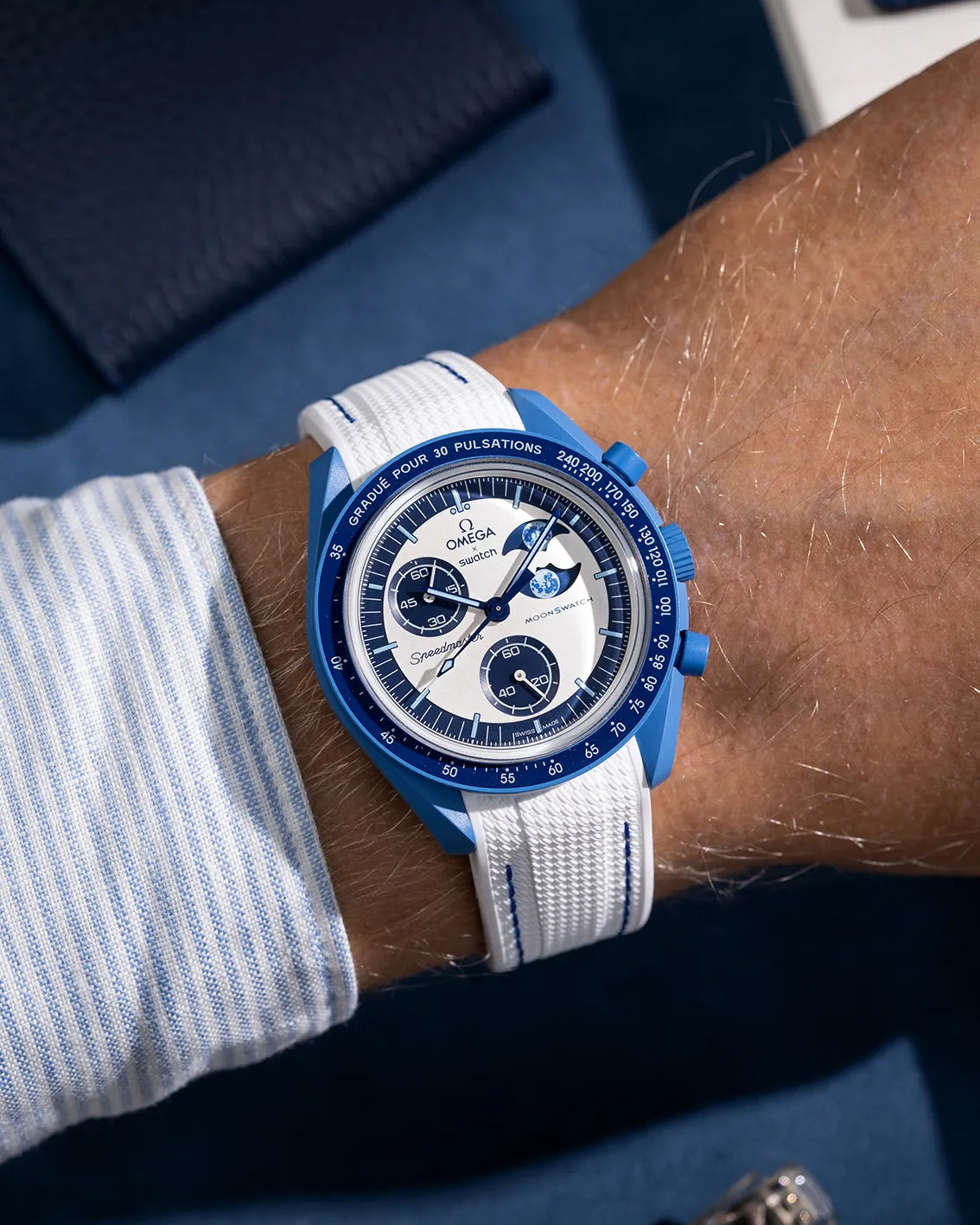 Wrist shot of white rubber strap with blue stitching for MoonSwatch, photographed on the Mission to the Super Blue Moonphase